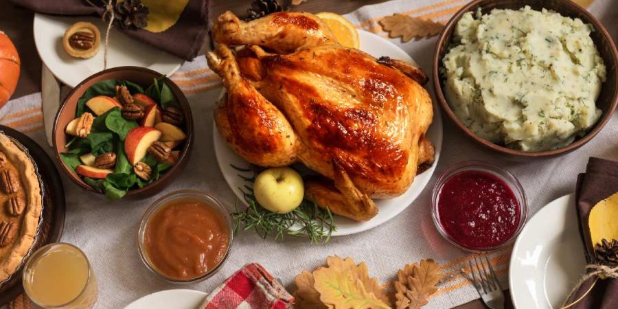 Dinner table arranged with a Thanksgiving feast