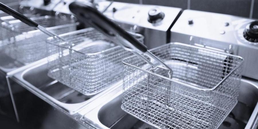 Clean deep frying machines inside a commercial kitchen